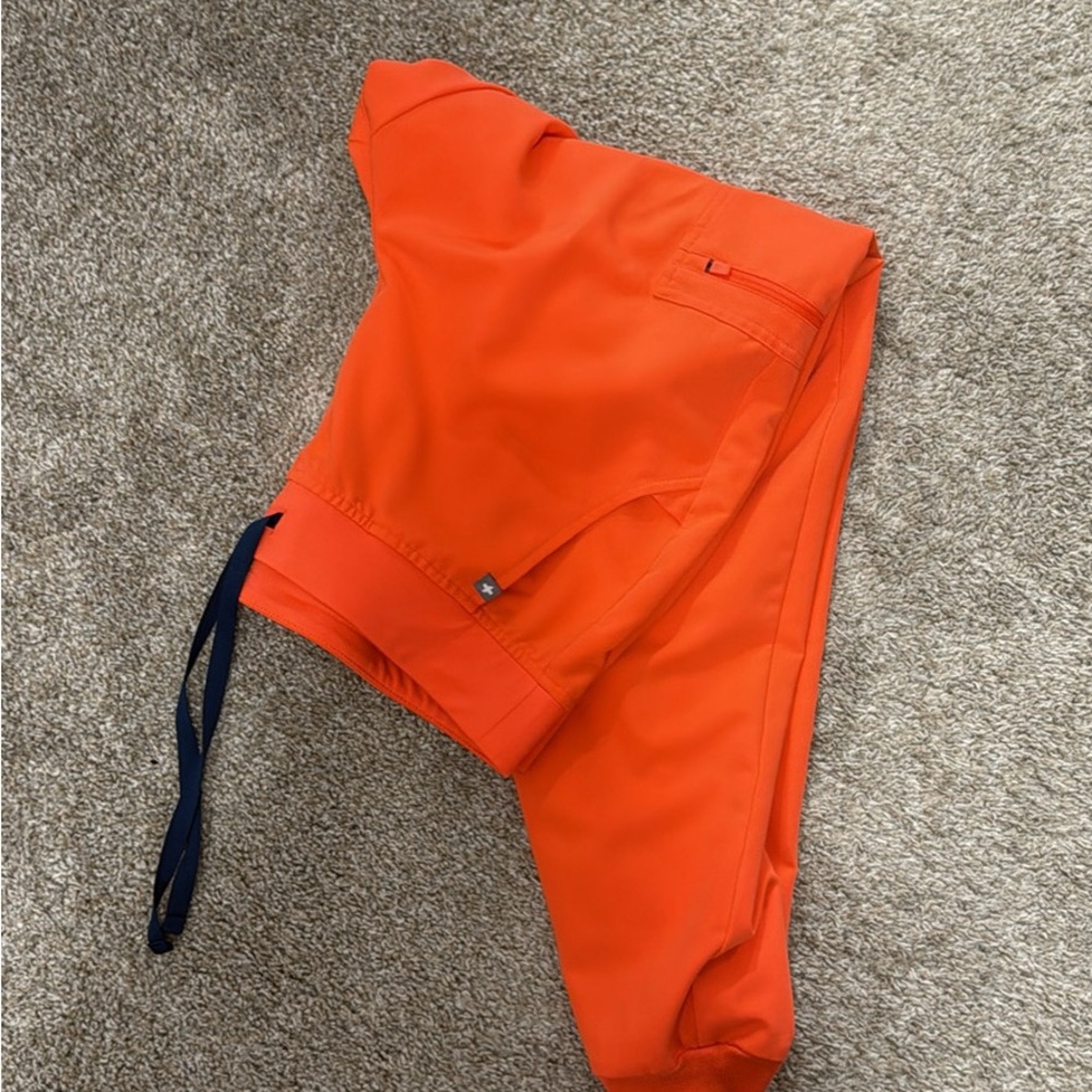 A set of Figs scrubs, bright orange color. Never worn, just washed once.